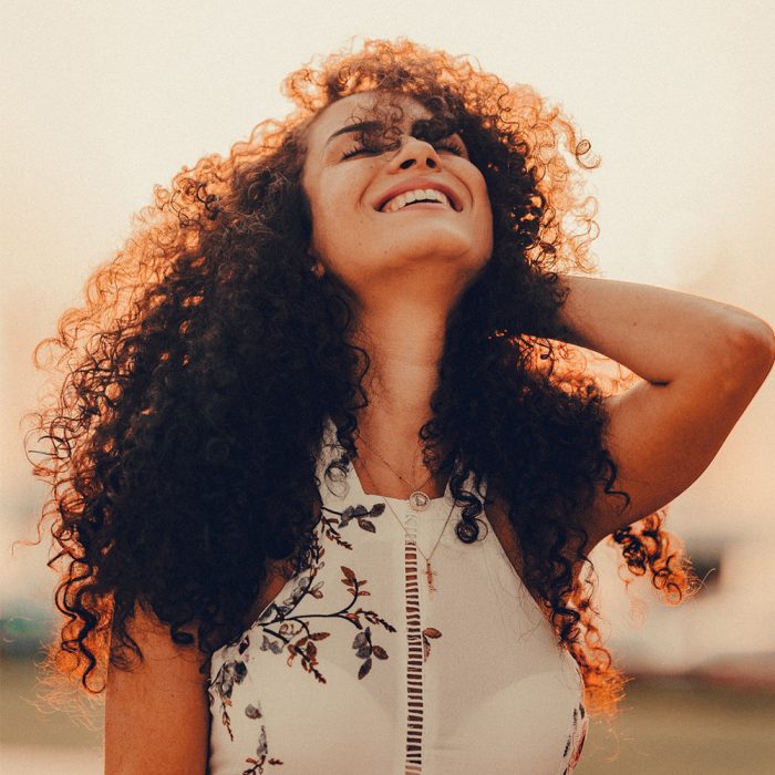 Smiling woman with curly brown hair