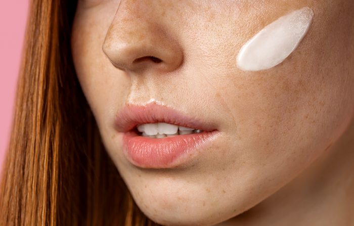 Winter Skincare tips - Woman with face moisturiser applied to cheek