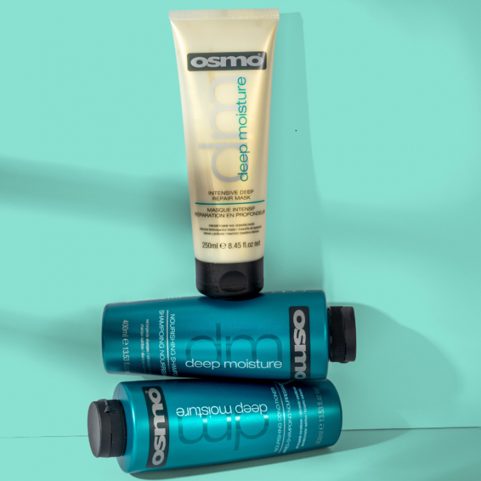 OSMO Deep Moisture Intensive Deep Repair Mask on top of OSMO Deep Repair Shampoo and Conditioner against a mint green background