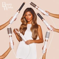 Woman with long caramel brown hair surrounded by Beauty Works AERIS Multi Stylers