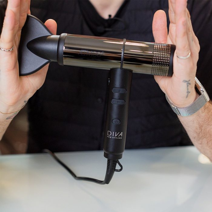 Man in a black t-shirt holding the Diva Pro Styling Atmos 2 Atom hair dryer between each hand