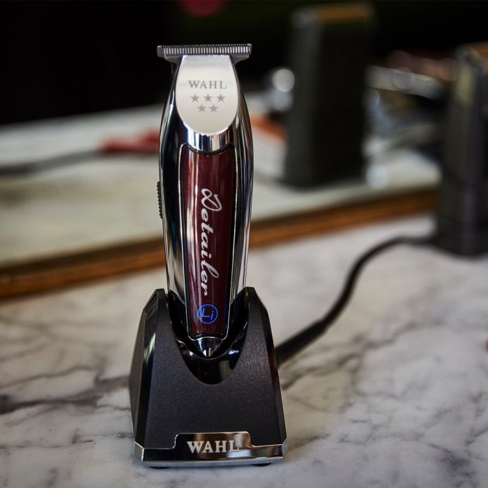 Wahl 5 Star Cordless Detailer Li Trimmer in charging dock on a marble workstation