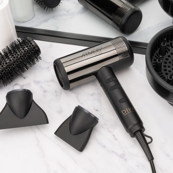 Diva Atmos 2 Ultra hair dryer on a marble background with nozzles and diffuser attachment