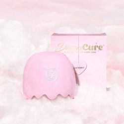 Glitterbels DreamCure nail lamp with box on a background of pink clouds