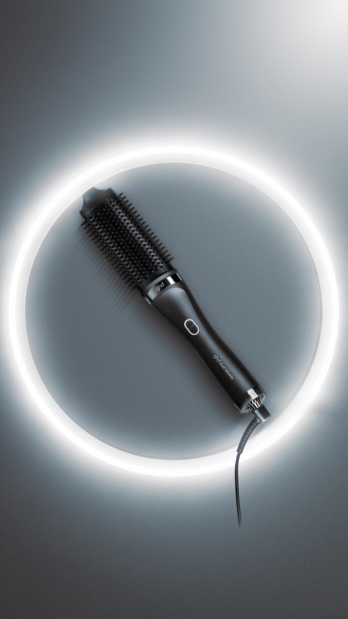 ghd duet blow dry hair dryer brush on a grey background with LED light halo
