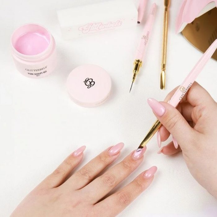 nail technician applying hard gel