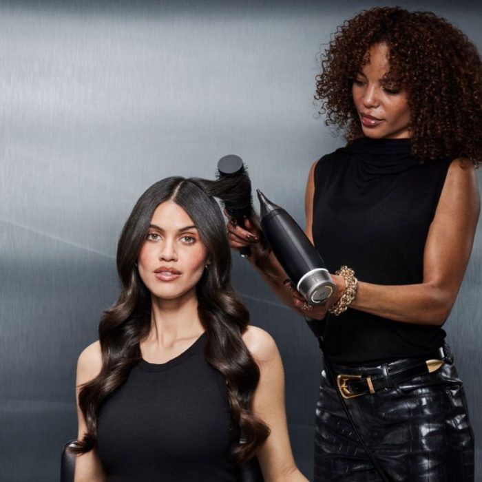 stylist using the ghd speed hairdryer to create bouncy curls