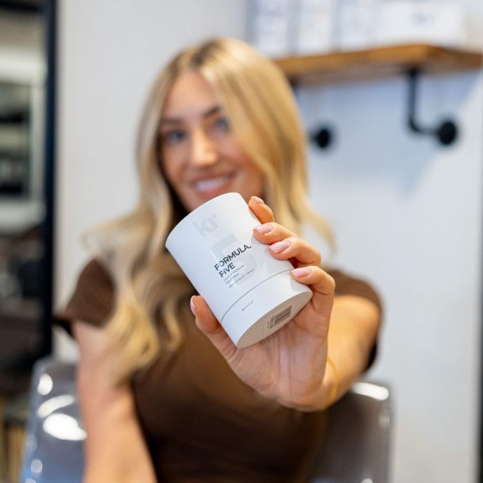 woman holding keratin revolution formula 5