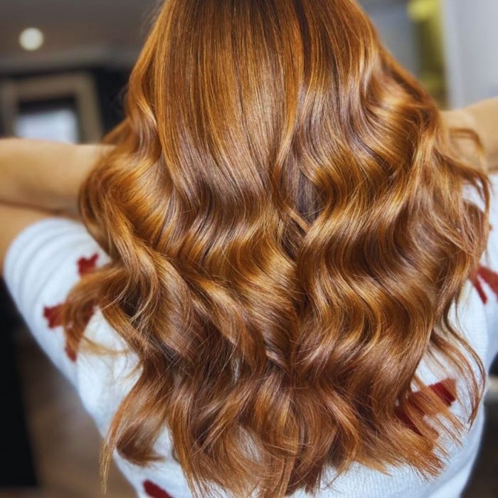 Image shows woman with cinnamon spice hair trend