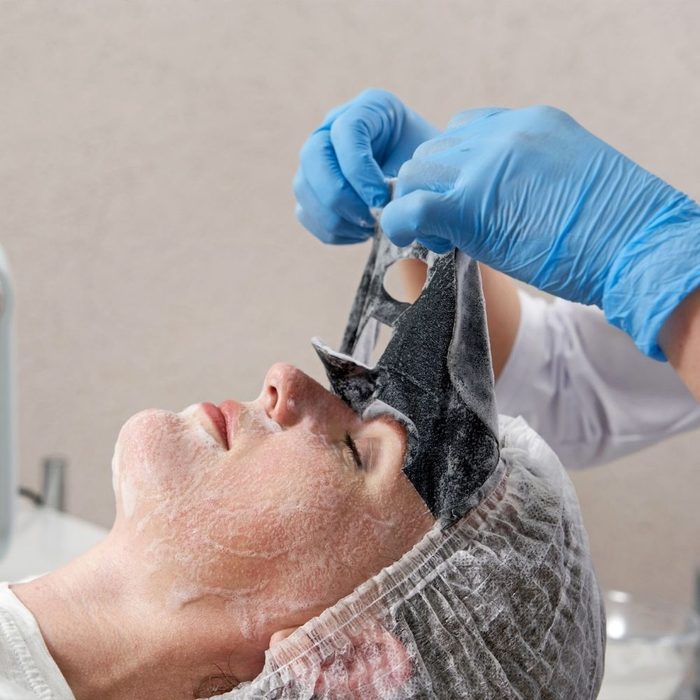 Woman having a facial using the Detoxifying Cleansing sheet mask