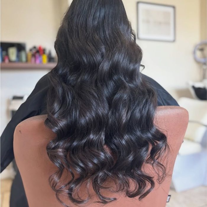 Image shows woman with vampy brunette hair trend